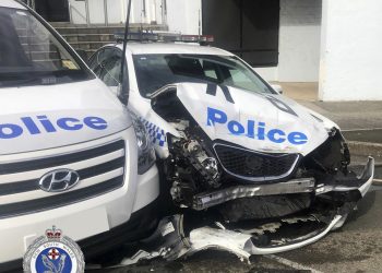 In this Monday, July 22, 2019, photo provided by New South Wales Police, a damaged police vehicle is parked at a police station in Sydney. Police have charged a driver after methylamphetamine valued at more than $140 million was found in a van that crashed into police cars parked outside the Sydney police station. (NSW Police via AP)