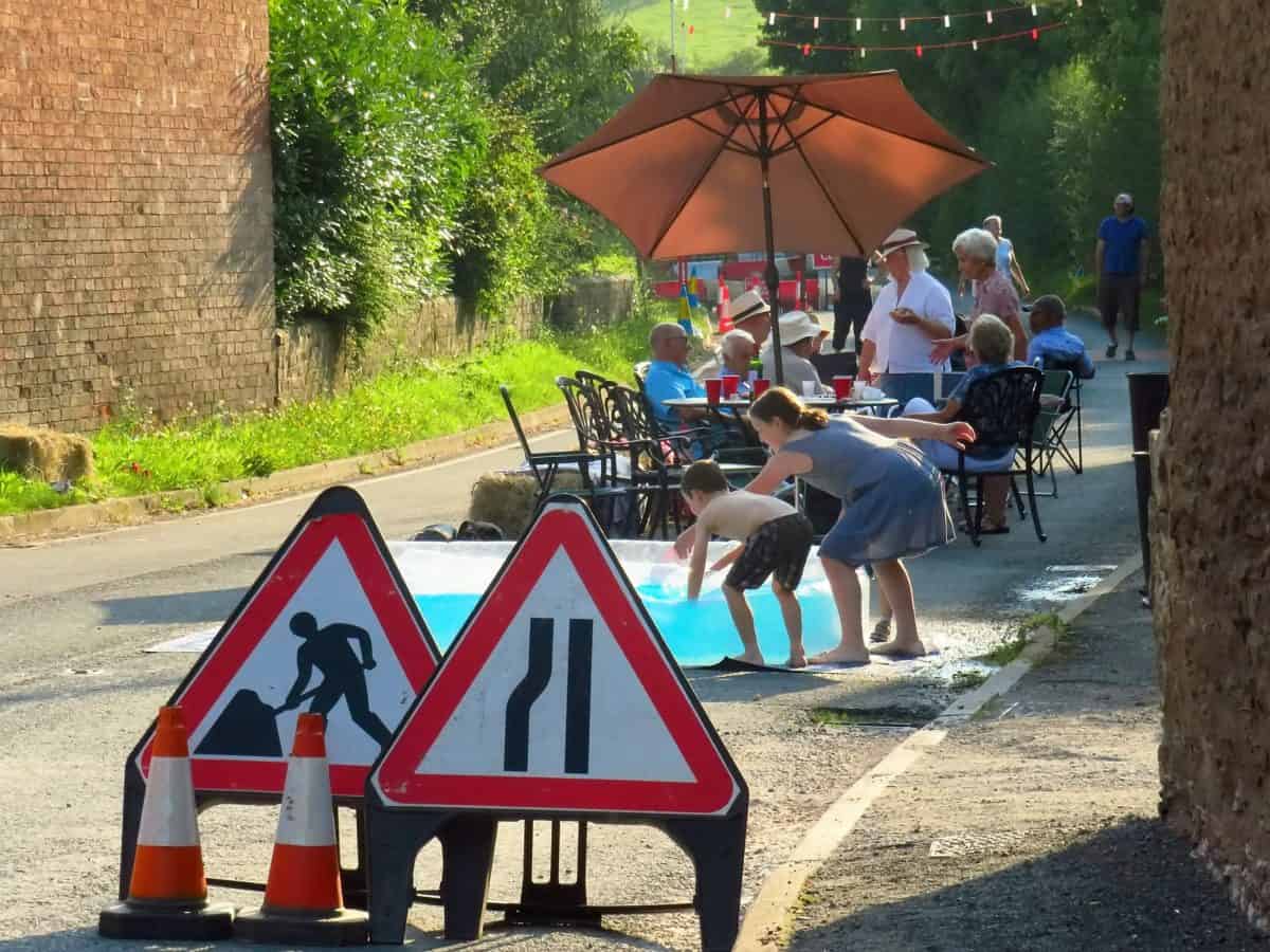 Villagers driven round bend by 26-mile diversion after 50m road closed have street party on shut highway