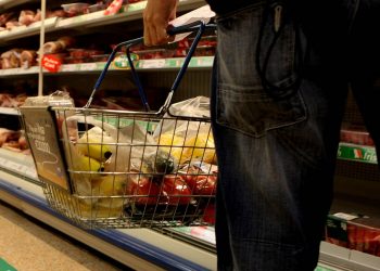 Undated file photo of a man holding a shopping basket in a supermarket. The price of food and drink will "go through the roof" if the UK leaves the EU without a deal, a new study suggests.