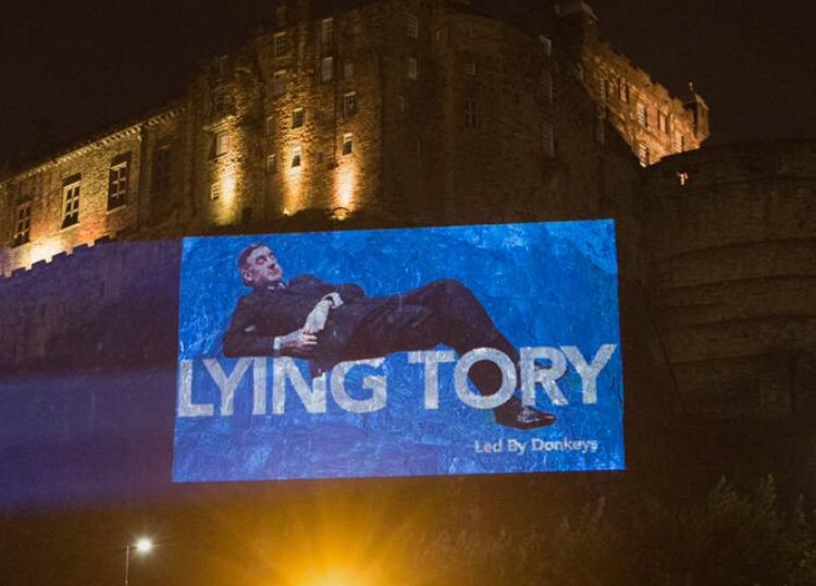 Edinburgh Castle lit up with giant picture of “lying Tory” Rees-Mogg