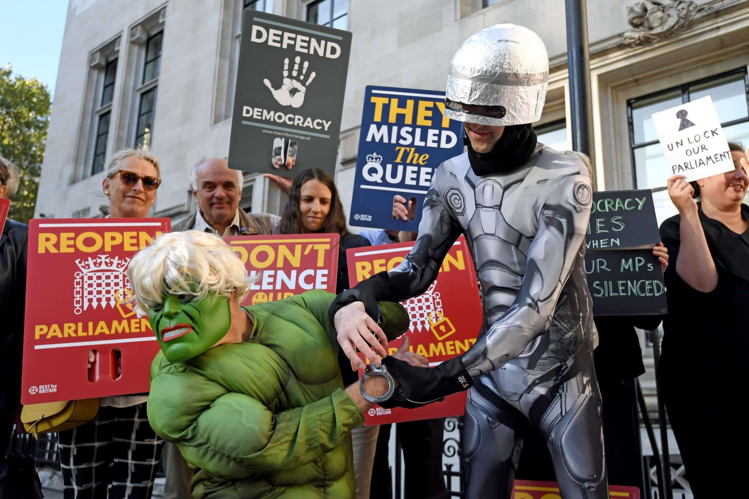 Protester dressed as the Hulk “arrested” by Robocop outside Supreme Court