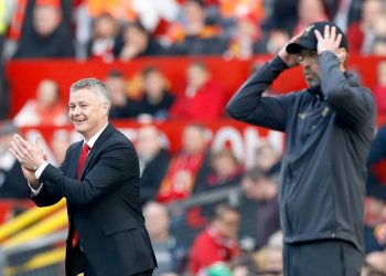 Manchester United caretaker manager Ole Gunnar Solskjaer (left) and Liverpool manager Jurgen Klopp react from the touchline during the Premier League match at Old Trafford, Manchester. Credit;PA