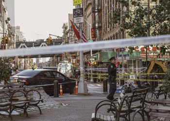 New York Police Department officers investigate the scene of an attack in Manhattan's Chinatown neighborhood, Saturday, Oct. 5, 2019 in New York. Four men who are believed to be homeless were brutally attacked and killed early Saturday in a street rampage. NYPD Detective Annette Shelton said that a fifth man remained in critical condition after also being struck with a long metal object that authorities recovered. (AP Photo/Jeenah Moon)