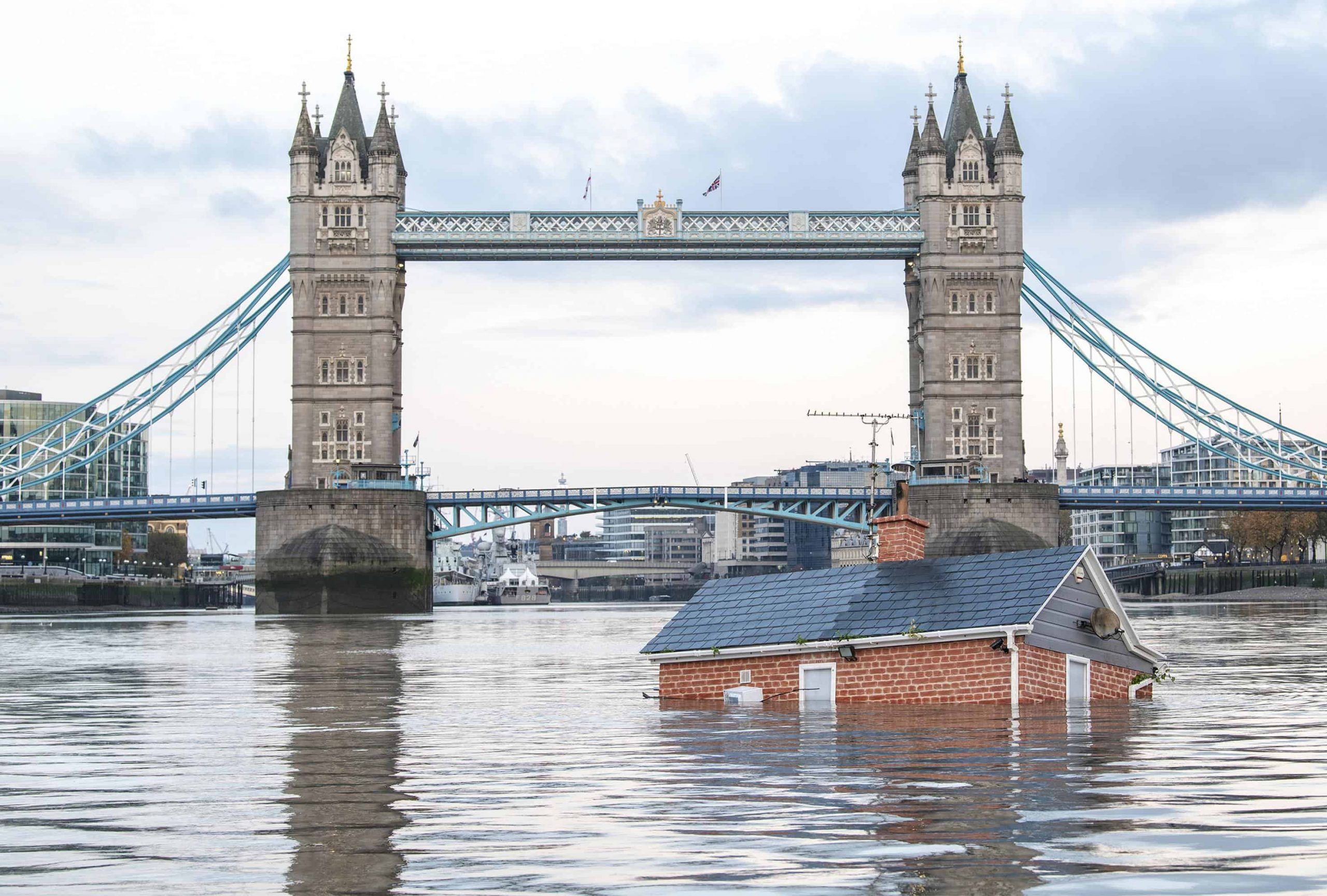 Extinction Rebellion protesters float ‘sinking house’ down Thames