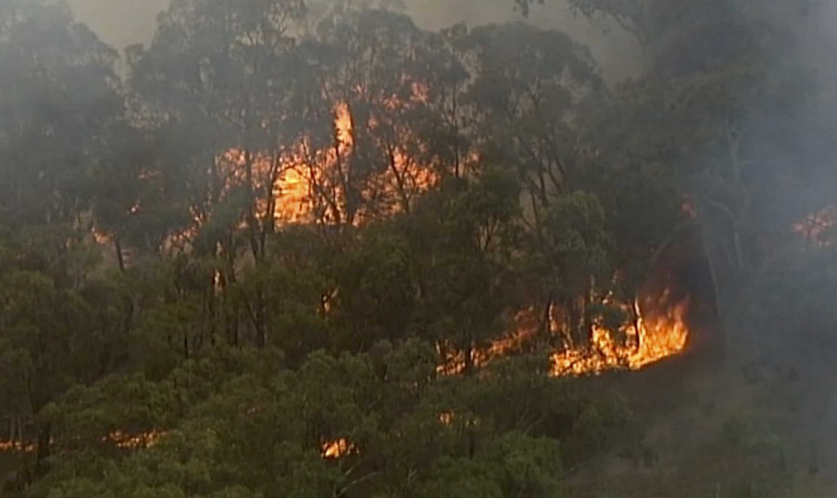 In this image made from video, an aerial scene showsfires burning in Bundoora, Victoria state, Monday, Dec. 30, 2019. New Year’s Eve fireworks in Australia’s capital and other cities have been canceled as the wildfire danger worsens in oppressive summer heat, and pressure was building for Sydney’s iconic celebrations to be similarly scrapped. (Australian Broadcasting Corporation, Channel 7, Channel 9 via AP)
