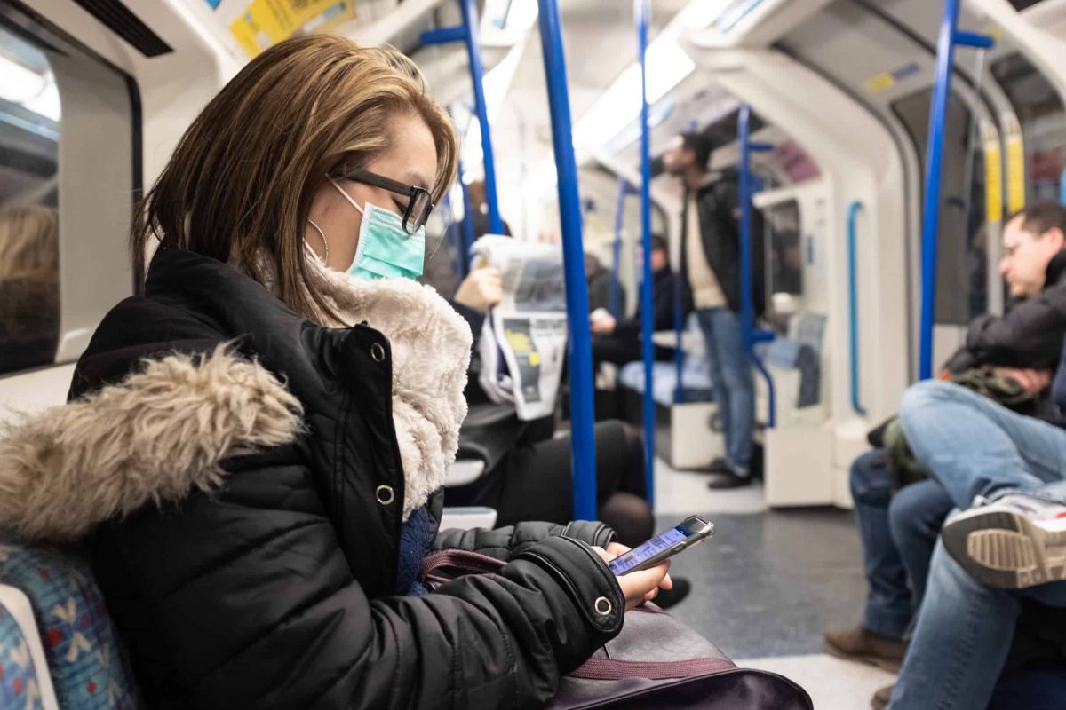 A woman wearing a facemask on the London Underground.
