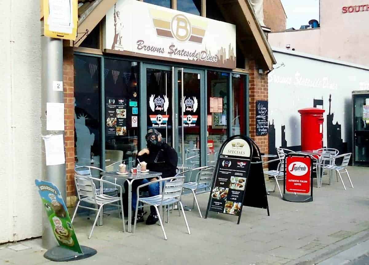 Picture shows man sat outside cafe – in Army issue gas mask