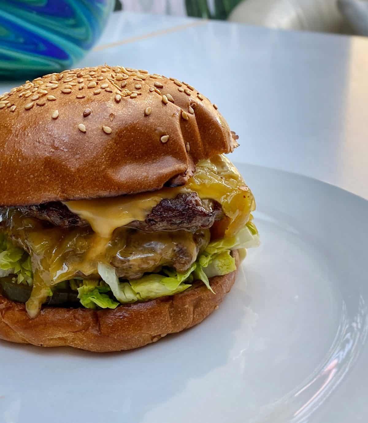 Peaky Blinders Manchester - Peaky Signature Burger ⁠ Ground brisket &  chunk steak patty, golden caramelised onions, black wax cheddar, shredded  lettuce and Peaky burger sauce. Perfectly paired with a cold pint