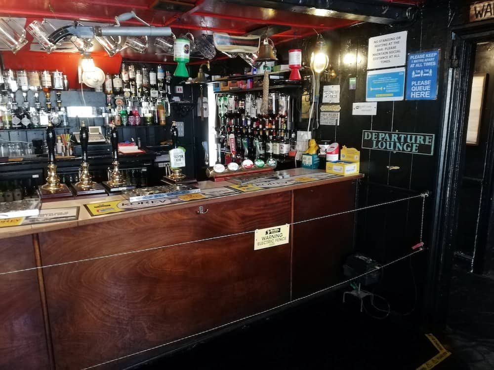 Pub ensures social distancing – by installing electric fence at the bar