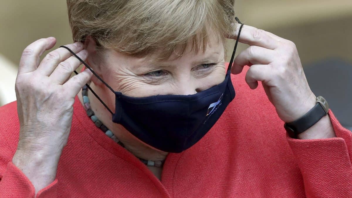 German Chancellor Angela Merkel adjusts her face mask as she arrives for a meeting of the upper house of the German legislative in Berlin, Germany, Friday, July 3, 2020. (AP Photo/Michael Sohn)