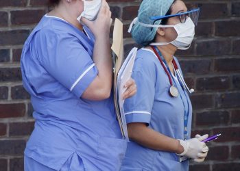 Hospital staff wear face masks outside Doncaster Royal Infirmary, as organisations representing hospital trusts have rounded on the Government over its promise of more personal protective equipment (PPE) to protect workers in the fight against Covid-19.