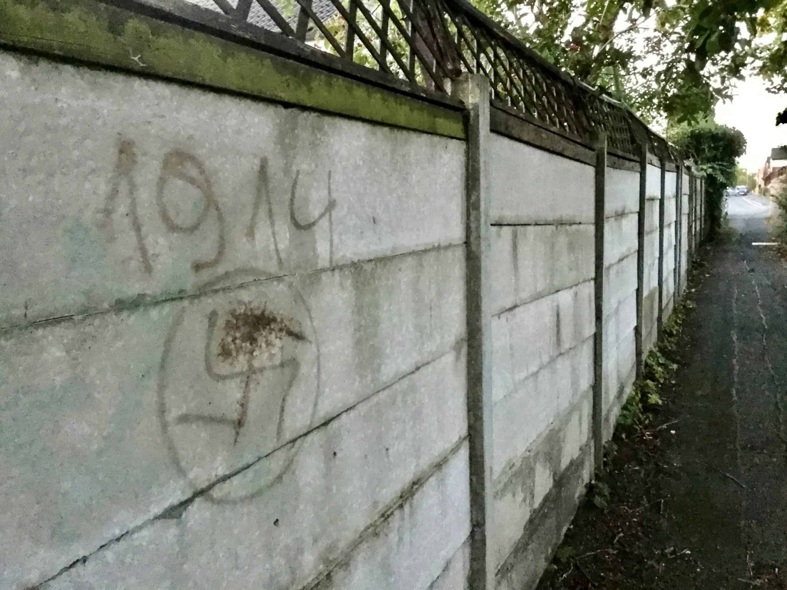 Racists target communities celebrating Jewish New Year by spray-painting swastika on wall