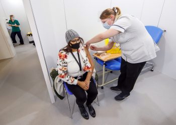 A woman receives an injection of the the Oxford/AstraZeneca coronavirus vaccine at Elland Road vaccine centre in Leeds, as a study shows that people from Asian and minority ethnic (BAME) groups living in deprived communities are more likely to be hesitant about the coronavirus vaccine than those in more affluent areas. Picture date: Friday March 12, 2021.