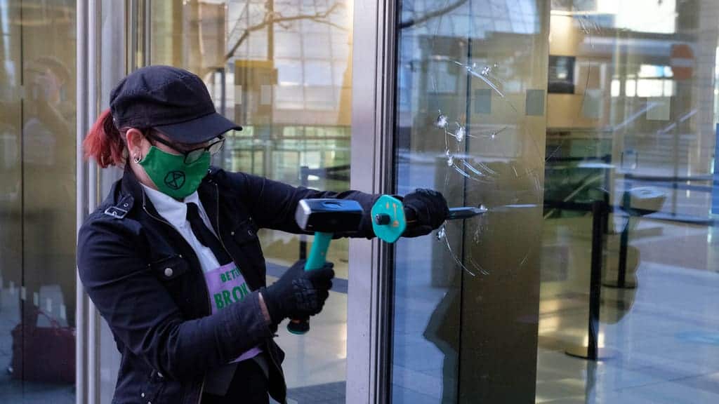 Extinction Rebellion protesters smash windows of Barclays HQ with chisels
