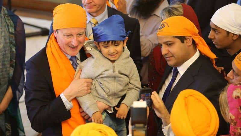 Samir Jassal (right) with David Cameron on a visit to a Sikh place of worship in Kent, 2015
