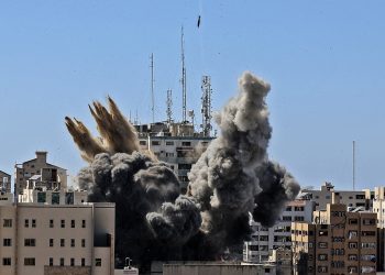 A bomb hits the building housing various international media (Mahmud Hams /Pool Photo via AP/PA)