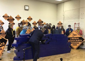 Ed Davey demolishing the blue wall after the Lib Dem victory in Chesham and Amersham