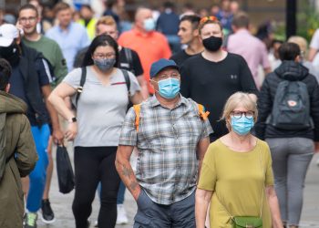 People wearing face masks among crowds of pedestrians in Covent Garden, London. Rumours were abound in the Sunday newspapers that Prime Minister Boris Johnson, who is due to update the nation this week on plans for unlocking, is due to scrap social distancing and mask-wearing requirements on so-called "Freedom Day". Picture date: Sunday July 4, 2021.