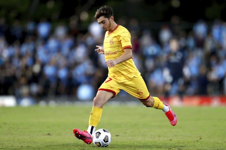 Josh Cavallo of the Adelaide United controls the ball during an A-League match between Sydney FC and Adelaide United in Sydney, on April 18, 2021. Cavallo came out in a series of social media posts and made comments about his experience in a video released Wednesday, Oct. 27, 2021, by his A-League club. Cavallo says he's the first active male player in the A-League to come out as gay. (Brendon Thorne/AAP Image via AP)