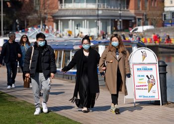 File photo dated 04/04/21 of people wearing protective face masks walking in Stratford-upon-Avon in Warwickshire. Scientists are calling for 3,000 long Covid sufferers of all ages, genders and ethnicities to help them establish a possible genetic link to the virus. Issue date: Wednesday September 1, 2021.