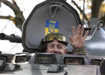 DONETSK DISTRICT, UKRAINE - OCTOBER 04: A soldier waves from an armored personnel carrier heading to the front lines on October 4, 2022 outside of Kramatorsk, Ukraine. Ukrainian Armed Forces pressed forward with gains in the east and south of the country, forcing Russia to retreat from several positions, with several villages liberated in the Kherson district. (Photo by Paula Bronstein/Getty Images)