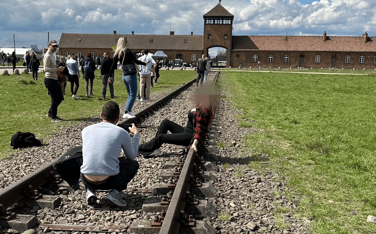 Woman sparks outrage after posing for photos on Auschwitz train tracks