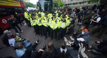 Protesters slash coach tyres to prevent migrants from being removed from London hotel
