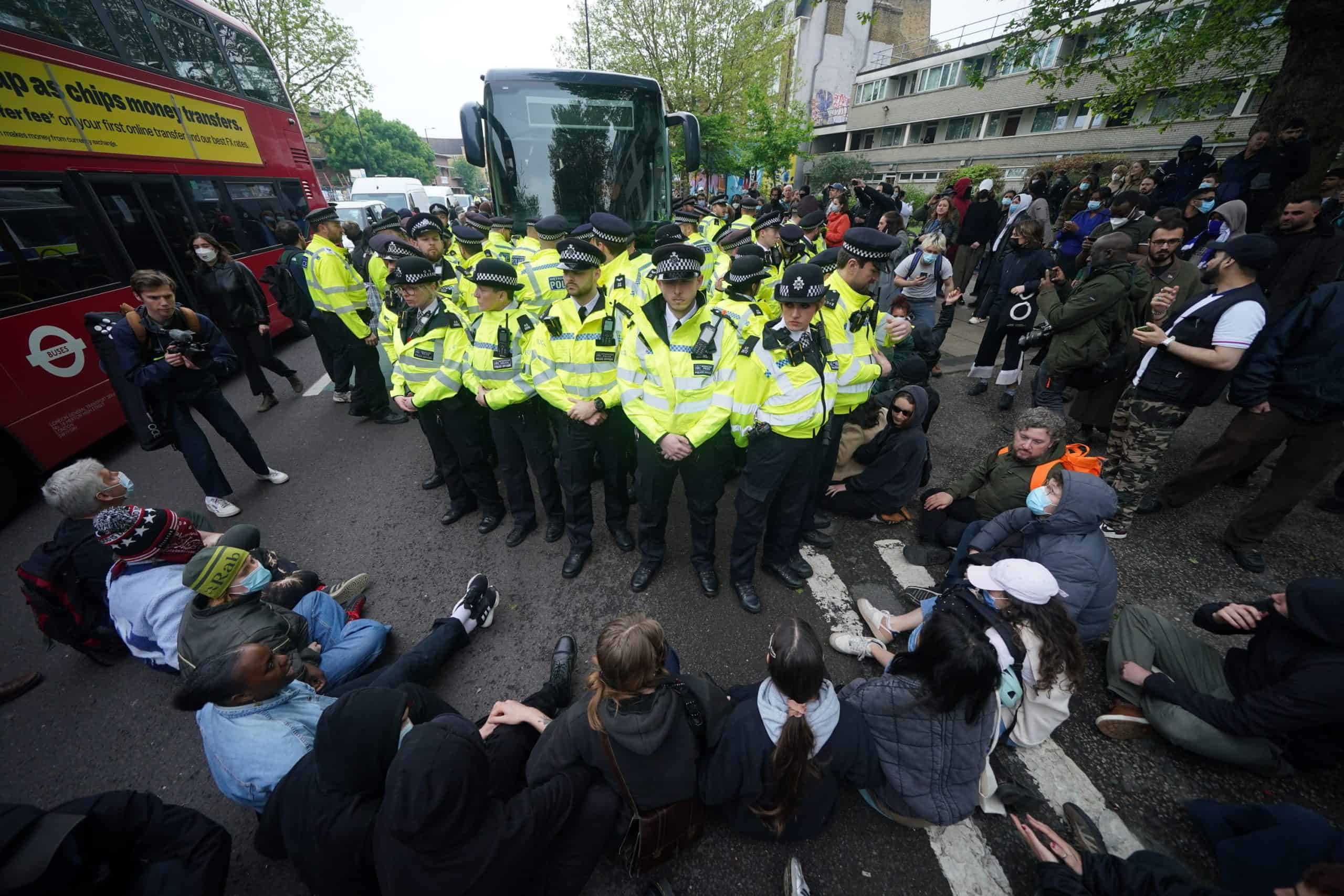 Protesters slash coach tyres to prevent migrants from being removed from London hotel